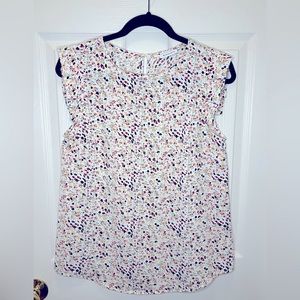 Sleeveless multi print blouse with flutter sleeve.